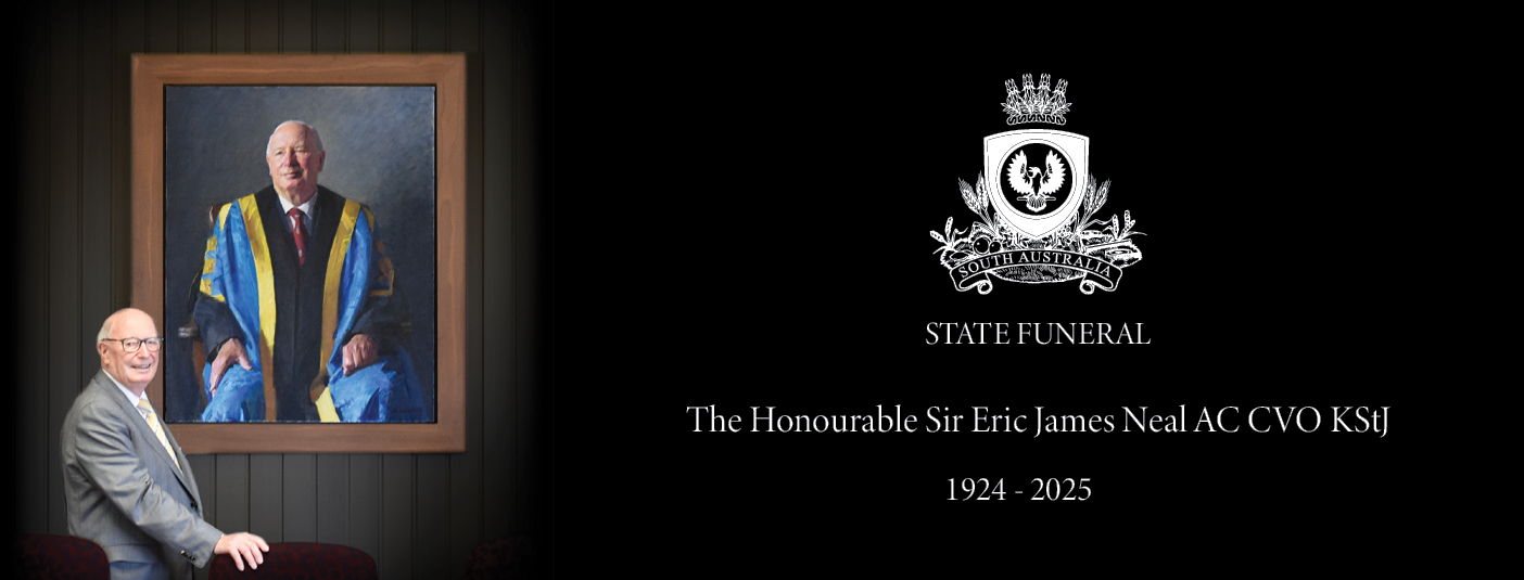 Sir Eric Neal standing in front of his portrait
