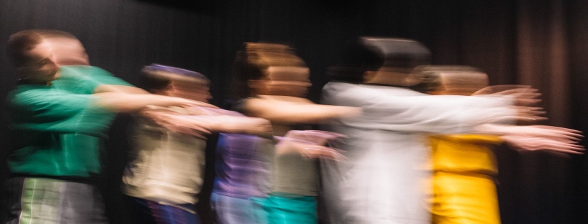 A group of five people dancing